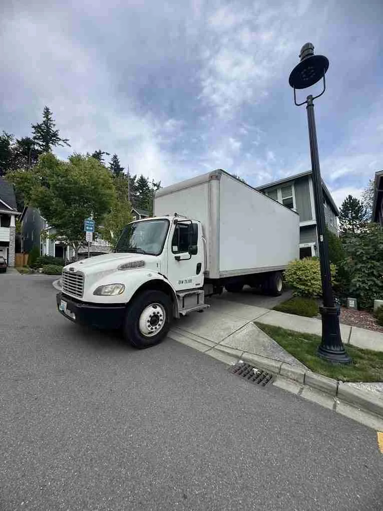 Strok Industries Moving box truck parked on a residential street